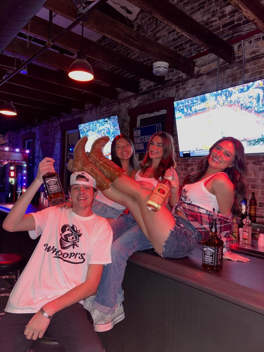 A group on the bar at Whoopi's